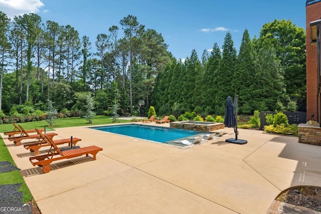 560 Arcaro Dr, Milton, GA 30004 - view of pool with a patio area, a pool with connected hot tub, a lawn, and view of scattered trees