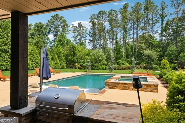 560 Arcaro Dr, Milton, GA 30004 - view of pool featuring a patio area, a pool with connected hot tub, view of wooded area, and area for grilling