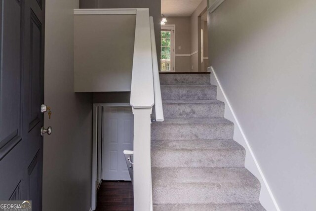 1404 Lancaster Ct, Mcdonough, GA 30252 - stairway featuring baseboards