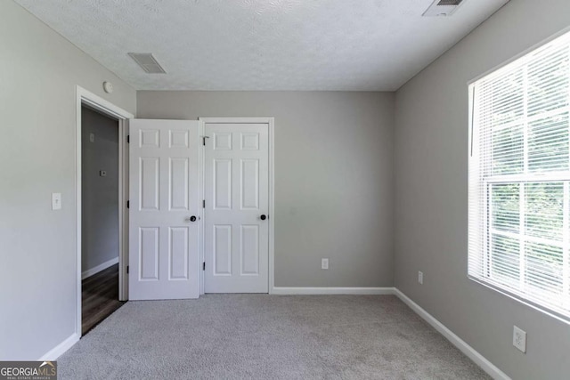 1404 Lancaster Ct, Mcdonough, GA 30252 - unfurnished bedroom with carpet, a textured ceiling, and a closet