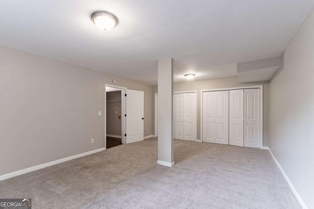1404 Lancaster Ct, Mcdonough, GA 30252 - unfurnished bedroom featuring carpet and two closets