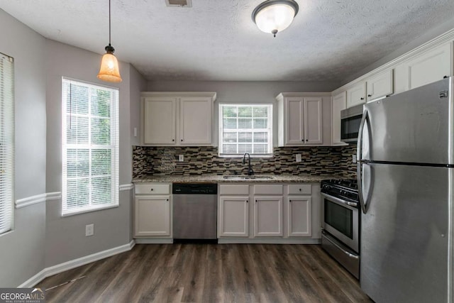 1404 Lancaster Ct, Mcdonough, GA 30252 - kitchen with appliances with stainless steel finishes, dark wood finished floors, tasteful backsplash, white cabinetry, and light stone countertops