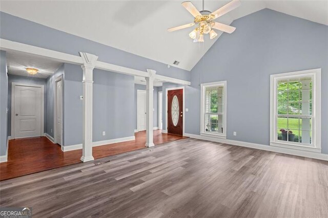 2333 Old Newnan Rd, Carrollton, GA 30116 - unfurnished living room with decorative columns, high vaulted ceiling, a ceiling fan, and wood finished floors