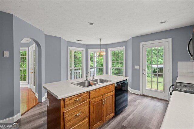 2333 Old Newnan Rd, Carrollton, GA 30116 - kitchen with black dishwasher, dark wood-style flooring, light countertops, arched walkways, and recessed lighting