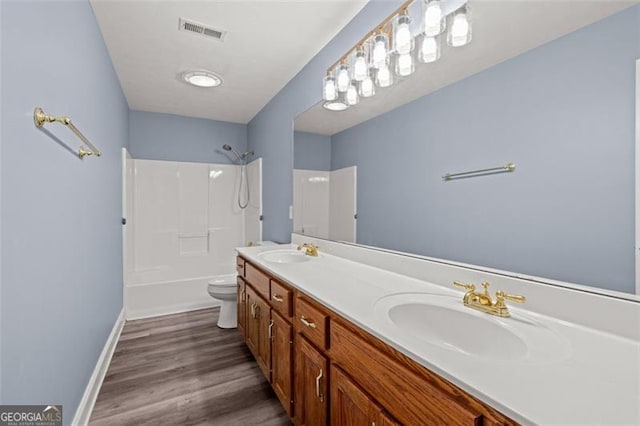 2333 Old Newnan Rd, Carrollton, GA 30116 - bathroom featuring double vanity, tub / shower combination, and wood finished floors