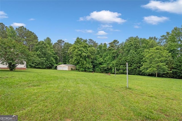 2333 Old Newnan Rd, Carrollton, GA 30116 - view of grassy yard featuring a view of trees and an outbuilding