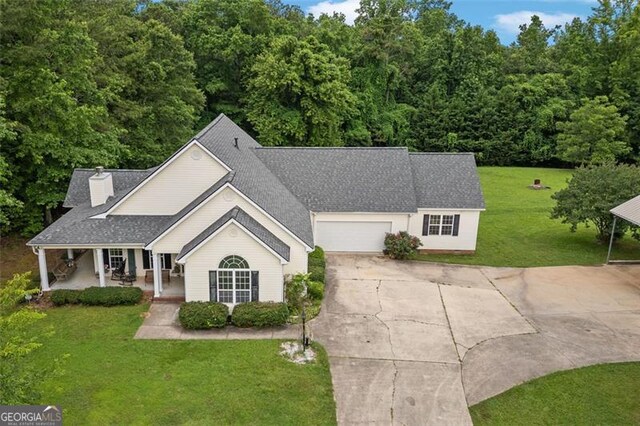 2333 Old Newnan Rd, Carrollton, GA 30116 - view of front of property featuring driveway, covered porch, a front yard, and a garage