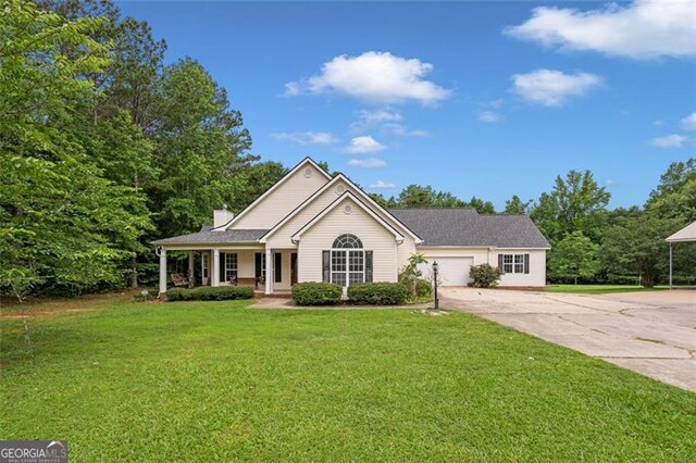 2333 Old Newnan Rd, Carrollton, GA 30116 - ranch-style home featuring driveway, a front lawn, covered porch, a garage, and a chimney