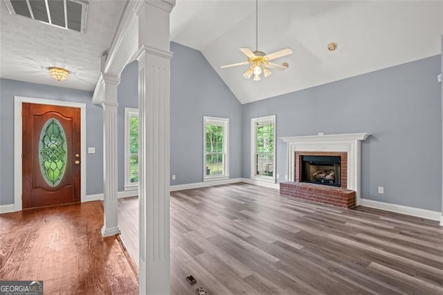 2333 Old Newnan Rd, Carrollton, GA 30116 - foyer featuring ornate columns, ceiling fan, high vaulted ceiling, a fireplace, and wood finished floors