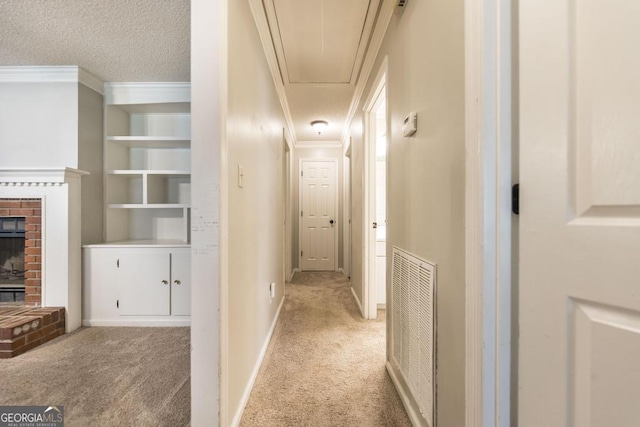 632 Chastain Pl, Macon, GA 31210 - corridor with light carpet, attic access, ornamental molding, and a textured ceiling