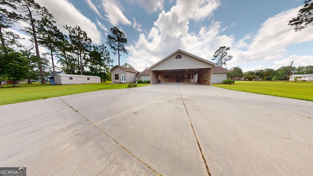 26 Ben Blvd, Swainsboro, GA 30401 - view of front of home with concrete driveway, a carport, and a front yard