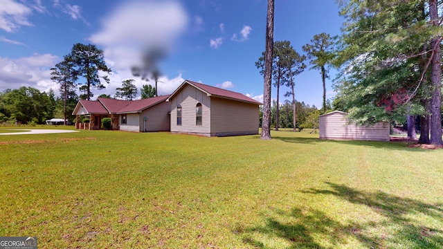 26 Ben Blvd, Swainsboro, GA 30401 - view of property exterior with a yard and a storage shed