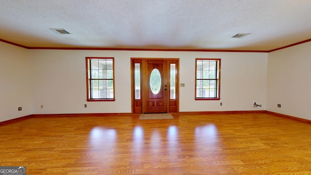 26 Ben Blvd, Swainsboro, GA 30401 - foyer with light wood-style floors, plenty of natural light, a textured ceiling, and crown molding