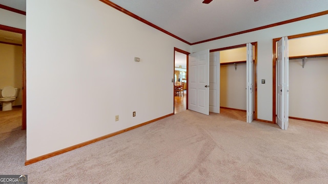 26 Ben Blvd, Swainsboro, GA 30401 - unfurnished bedroom featuring carpet floors, two closets, crown molding, and a ceiling fan
