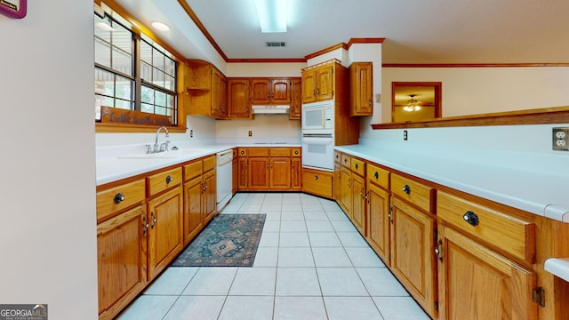 26 Ben Blvd, Swainsboro, GA 30401 - kitchen featuring white appliances, brown cabinetry, light countertops, light tile patterned floors, and under cabinet range hood