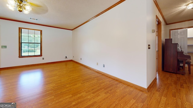 26 Ben Blvd, Swainsboro, GA 30401 - unfurnished room with crown molding, light wood-style floors, a textured ceiling, and ceiling fan