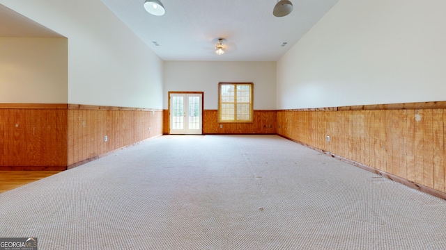 26 Ben Blvd, Swainsboro, GA 30401 - unfurnished room featuring a wainscoted wall, carpet flooring, wood walls, and french doors