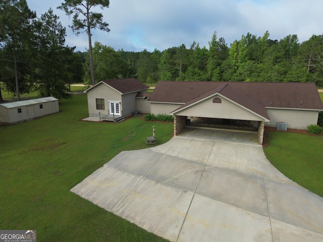 26 Ben Blvd, Swainsboro, GA 30401 - single story home with a forest view, a front yard, concrete driveway, and an outdoor structure