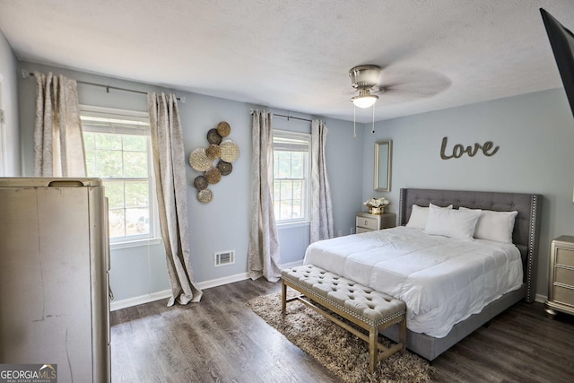 5567 Executive Way, Norcross, GA 30071 - bedroom with dark wood-style floors, a ceiling fan, and a textured ceiling