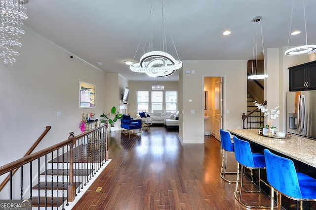 1306 Harris Way, Brookhaven, GA 30319 - kitchen with stainless steel fridge with ice dispenser, dark wood-style floors, light stone counters, ornamental molding, and decorative light fixtures