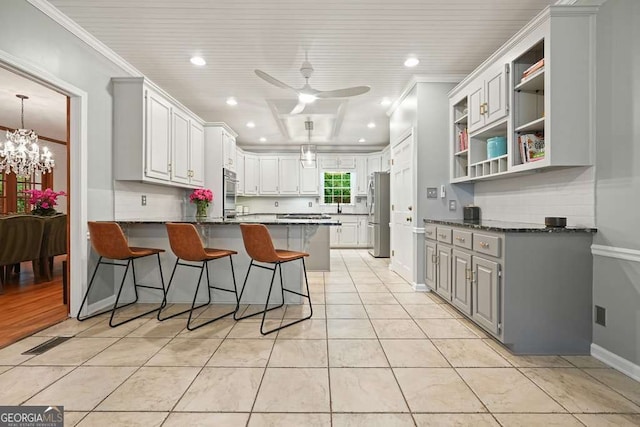 627 Apache Trl, Woodstock, GA 30189 - kitchen featuring freestanding refrigerator, a peninsula, light tile patterned flooring, a kitchen breakfast bar, and open shelves