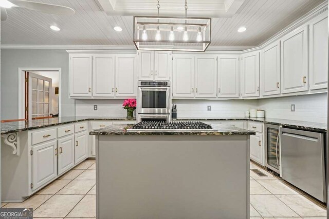 627 Apache Trl, Woodstock, GA 30189 - kitchen with stainless steel appliances, wine cooler, ornamental molding, white cabinetry, and dark stone countertops