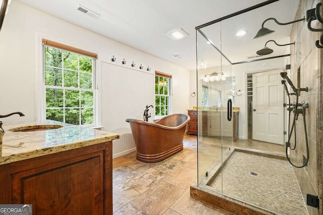 627 Apache Trl, Woodstock, GA 30189 - bathroom with a stall shower, vanity, and a freestanding tub