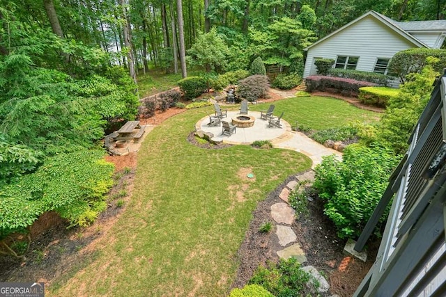 627 Apache Trl, Woodstock, GA 30189 - view of green lawn featuring an outdoor fire pit and a patio area