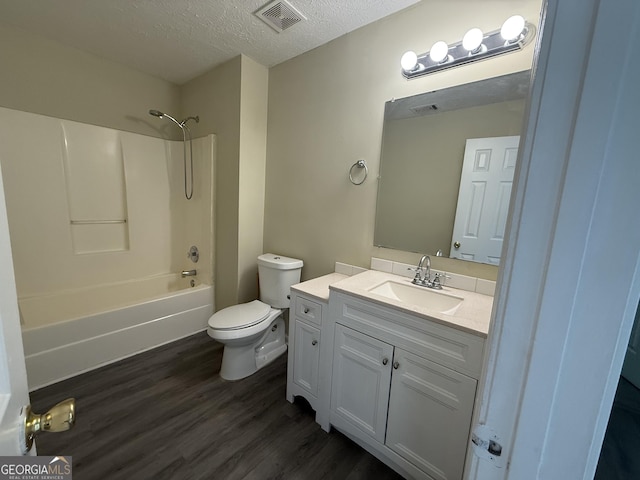 756 Glenshire Ct, Riverdale, GA 30274 - full bathroom featuring vanity, wood finished floors, a textured ceiling, and washtub / shower combination