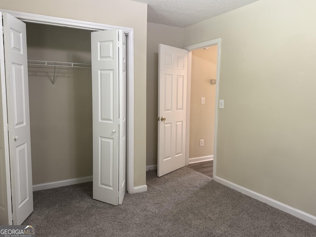 756 Glenshire Ct, Riverdale, GA 30274 - unfurnished bedroom with carpet, a closet, and a textured ceiling