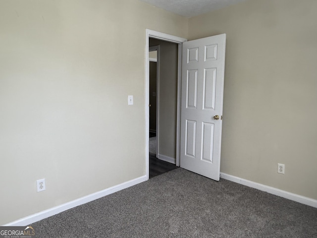 756 Glenshire Ct, Riverdale, GA 30274 - unfurnished room with dark carpet and baseboards