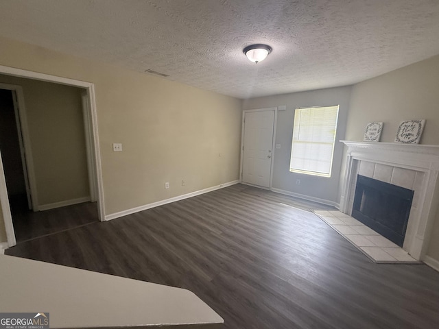 756 Glenshire Ct, Riverdale, GA 30274 - unfurnished living room featuring wood finished floors, a fireplace, and a textured ceiling