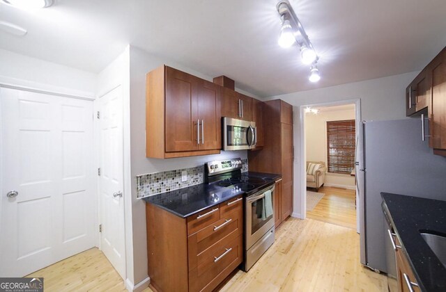 221 College Cir, Athens, GA 30605 - kitchen with stainless steel appliances, light wood-type flooring, and dark stone countertops
