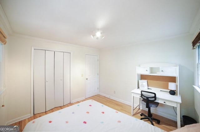221 College Cir, Athens, GA 30605 - bedroom featuring light wood-type flooring, ornamental molding, a closet, and an office area
