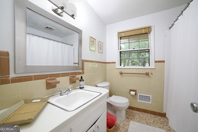 221 College Cir, Athens, GA 30605 - bathroom featuring tile walls, vanity, and wainscoting