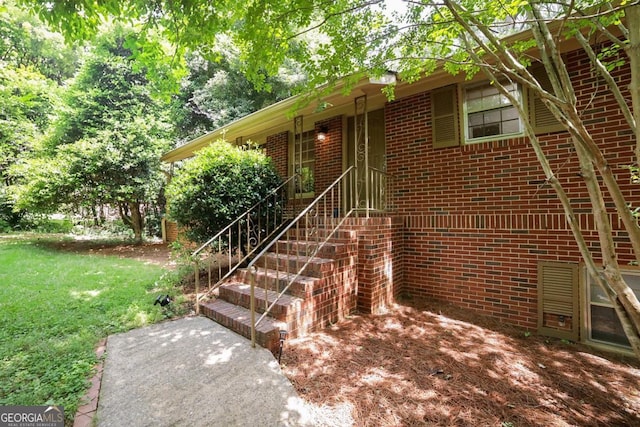 221 College Cir, Athens, GA 30605 - view of exterior entry featuring brick siding and a lawn