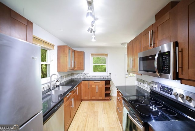 221 College Cir, Athens, GA 30605 - kitchen with stainless steel appliances, light wood finished floors, dark stone countertops, glass insert cabinets, and brown cabinets