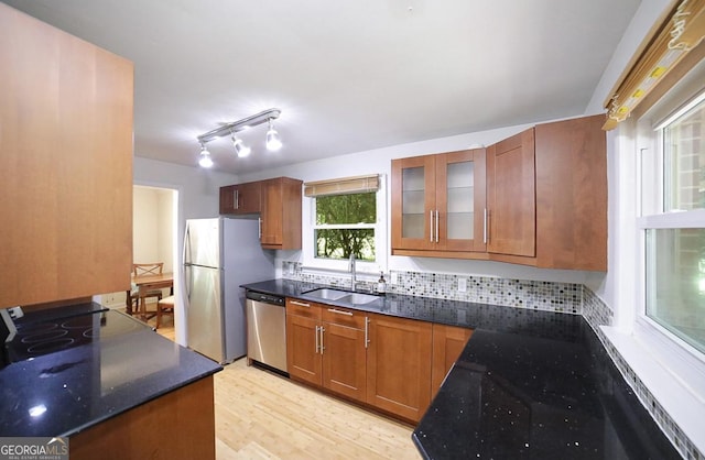 221 College Cir, Athens, GA 30605 - kitchen with appliances with stainless steel finishes, light wood-type flooring, glass insert cabinets, and brown cabinets