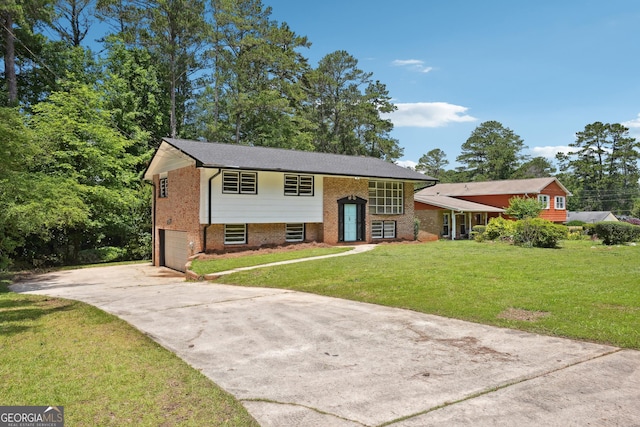 3611 Radcliffe Blvd, Decatur, GA 30034 - split foyer home with concrete driveway, an attached garage, brick siding, and a front lawn
