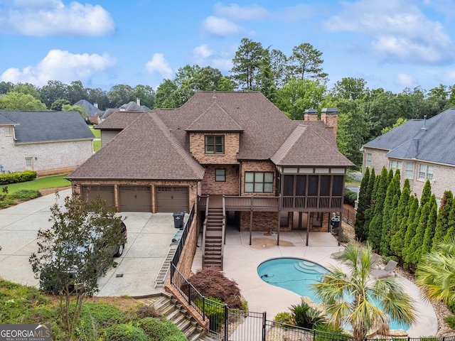 3410 Enclave Mill Ct, Dacula, GA 30019 - rear view of house featuring stairs, roof with shingles, a sunroom, a fenced backyard, and a chimney