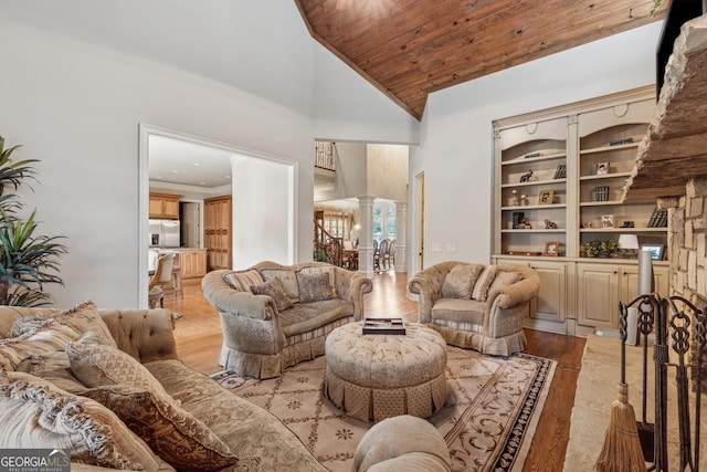 3410 Enclave Mill Ct, Dacula, GA 30019 - living area with decorative columns, light wood finished floors, high vaulted ceiling, and wooden ceiling