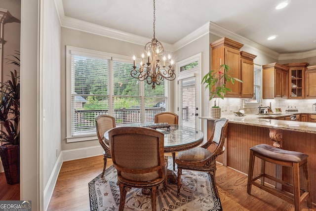 3410 Enclave Mill Ct, Dacula, GA 30019 - dining room with a chandelier, light wood-style flooring, crown molding, and recessed lighting