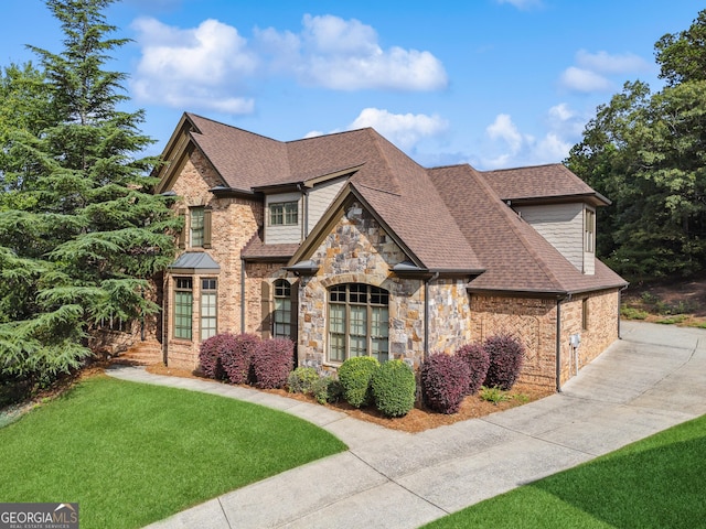 3410 Enclave Mill Ct, Dacula, GA 30019 - view of front of property with stone siding, a front yard, and roof with shingles