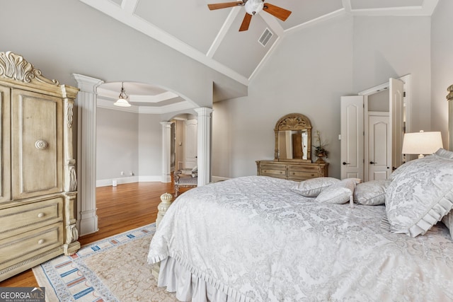 3410 Enclave Mill Ct, Dacula, GA 30019 - bedroom featuring ornate columns, arched walkways, high vaulted ceiling, light wood-type flooring, and ornamental molding