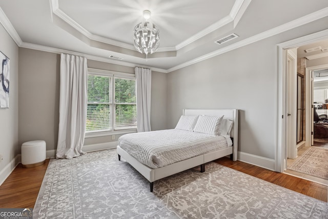 3410 Enclave Mill Ct, Dacula, GA 30019 - bedroom with a raised ceiling, ornamental molding, wood finished floors, and a chandelier