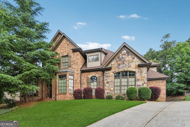3410 Enclave Mill Ct, Dacula, GA 30019 - view of front of home with stone siding, a front yard, and roof with shingles
