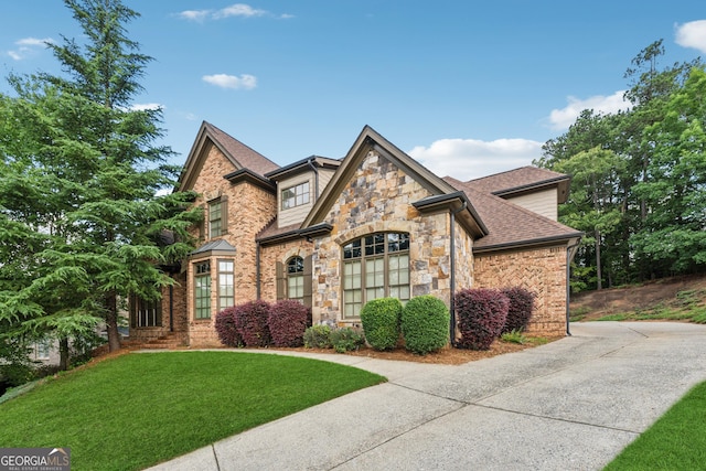 3410 Enclave Mill Ct, Dacula, GA 30019 - view of front of home with stone siding, a front yard, roof with shingles, and concrete driveway
