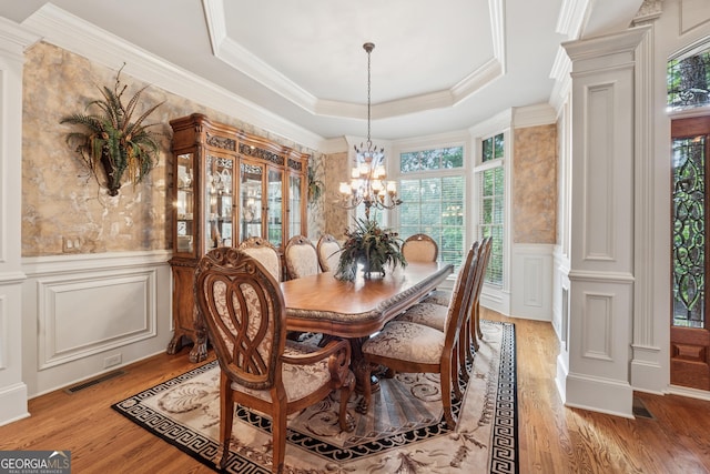 3410 Enclave Mill Ct, Dacula, GA 30019 - dining space featuring a decorative wall, healthy amount of natural light, light wood-style flooring, a chandelier, and wainscoting