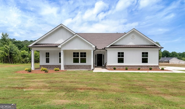 797 Ode Peppers Rd, Winder, GA 30680 - modern farmhouse style home with roof with shingles, a front yard, brick siding, and covered porch