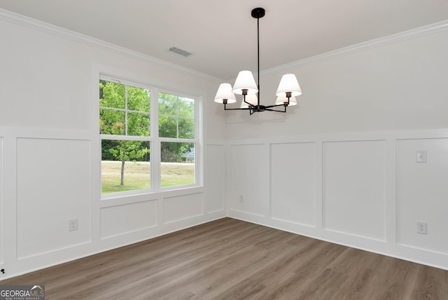 797 Ode Peppers Rd, Winder, GA 30680 - unfurnished dining area featuring a decorative wall, a chandelier, crown molding, wood finished floors, and a wainscoted wall